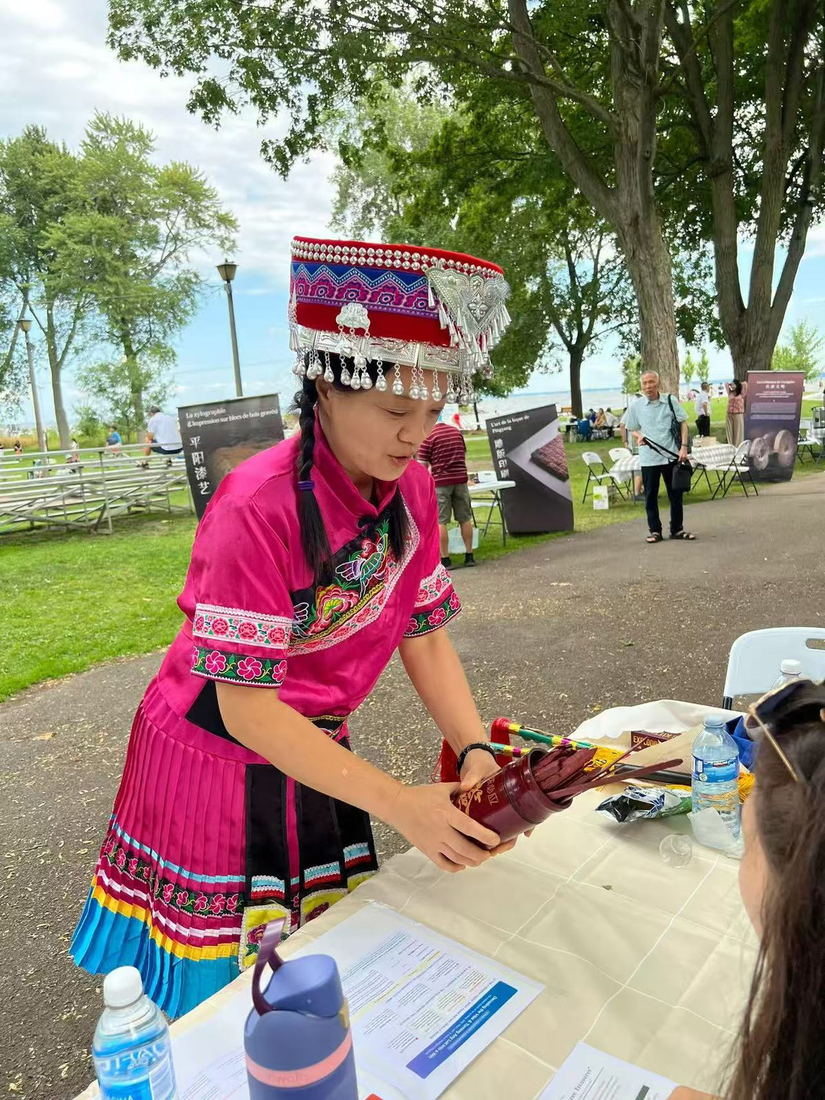 Fortune stick demonstration in traditional dress